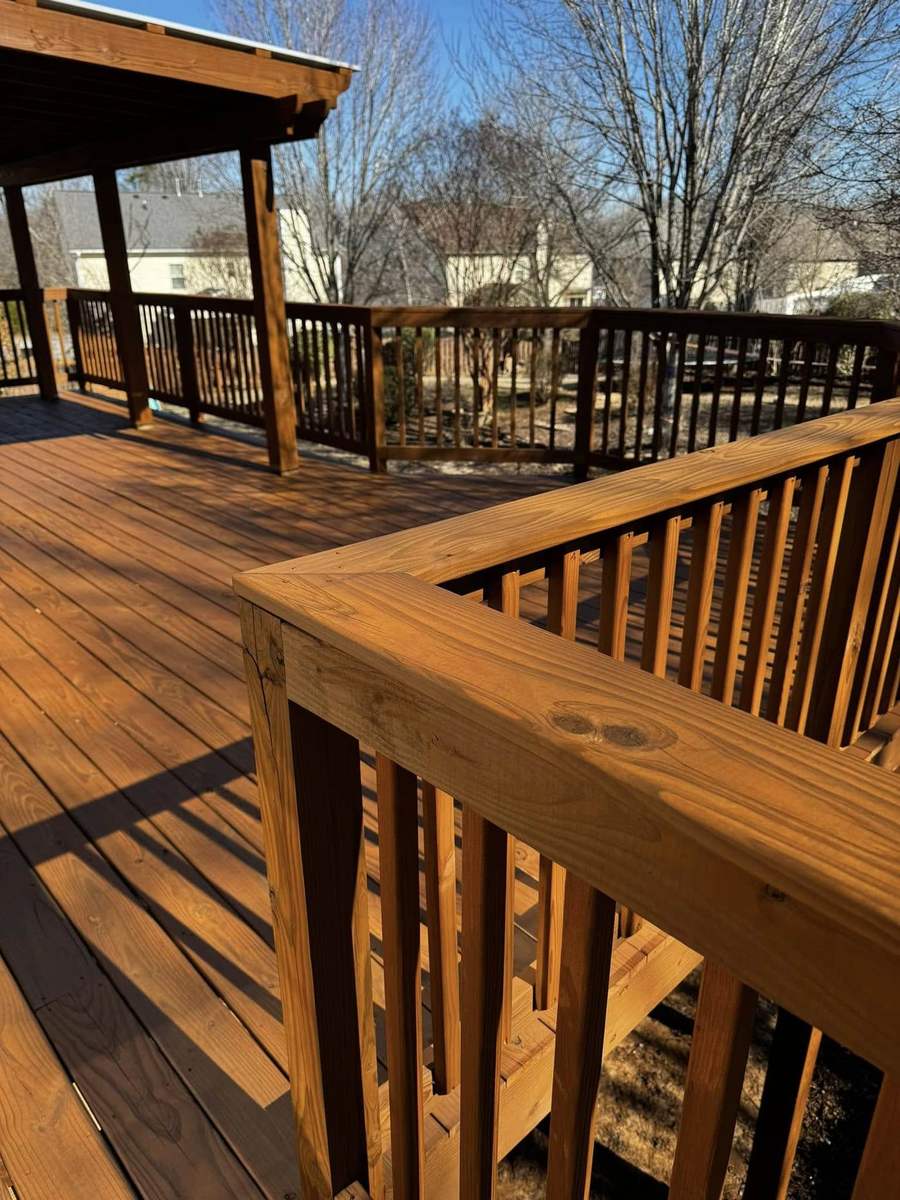 Warm brown stained deck boards filling the frame with sky