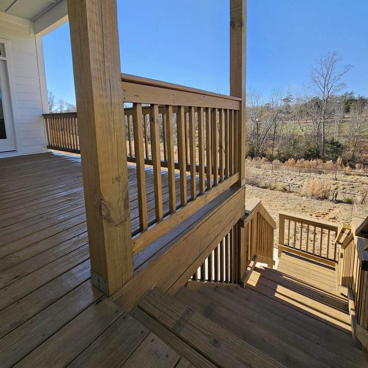 Stained deck and porch corner under blue sky