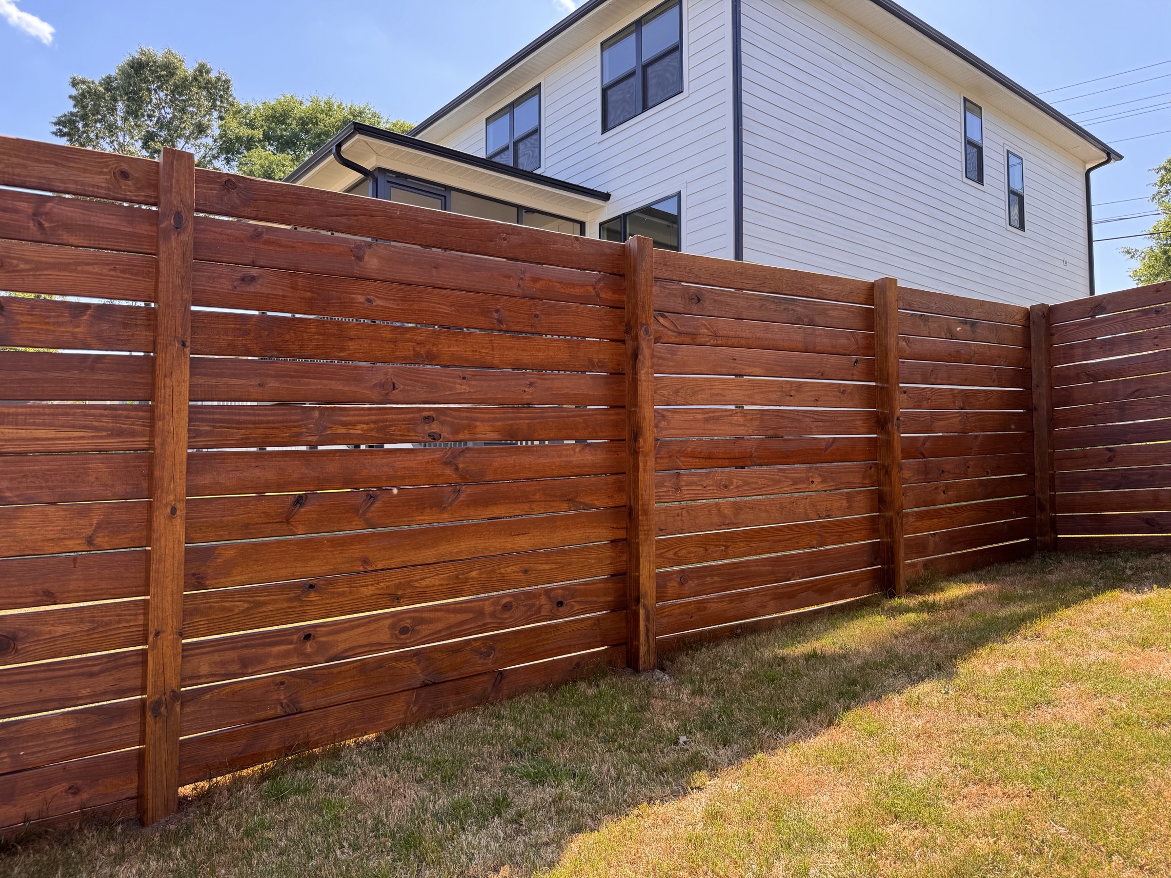 Horizontal wood fence with a rich professional stain in Upstate South Carolina